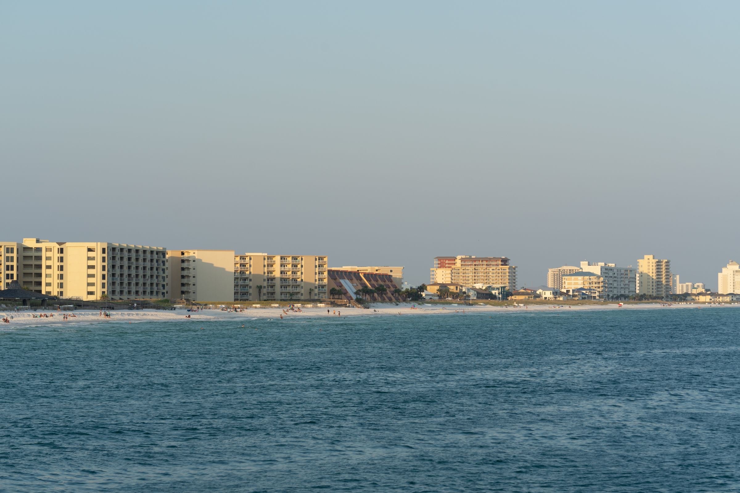 The Destin beachfront across the water at sunset
