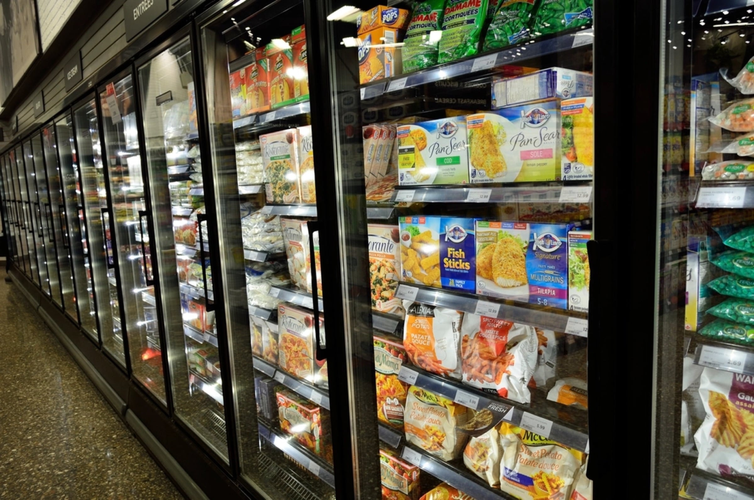 A supermarket freezer aisle lined with glass-door cases