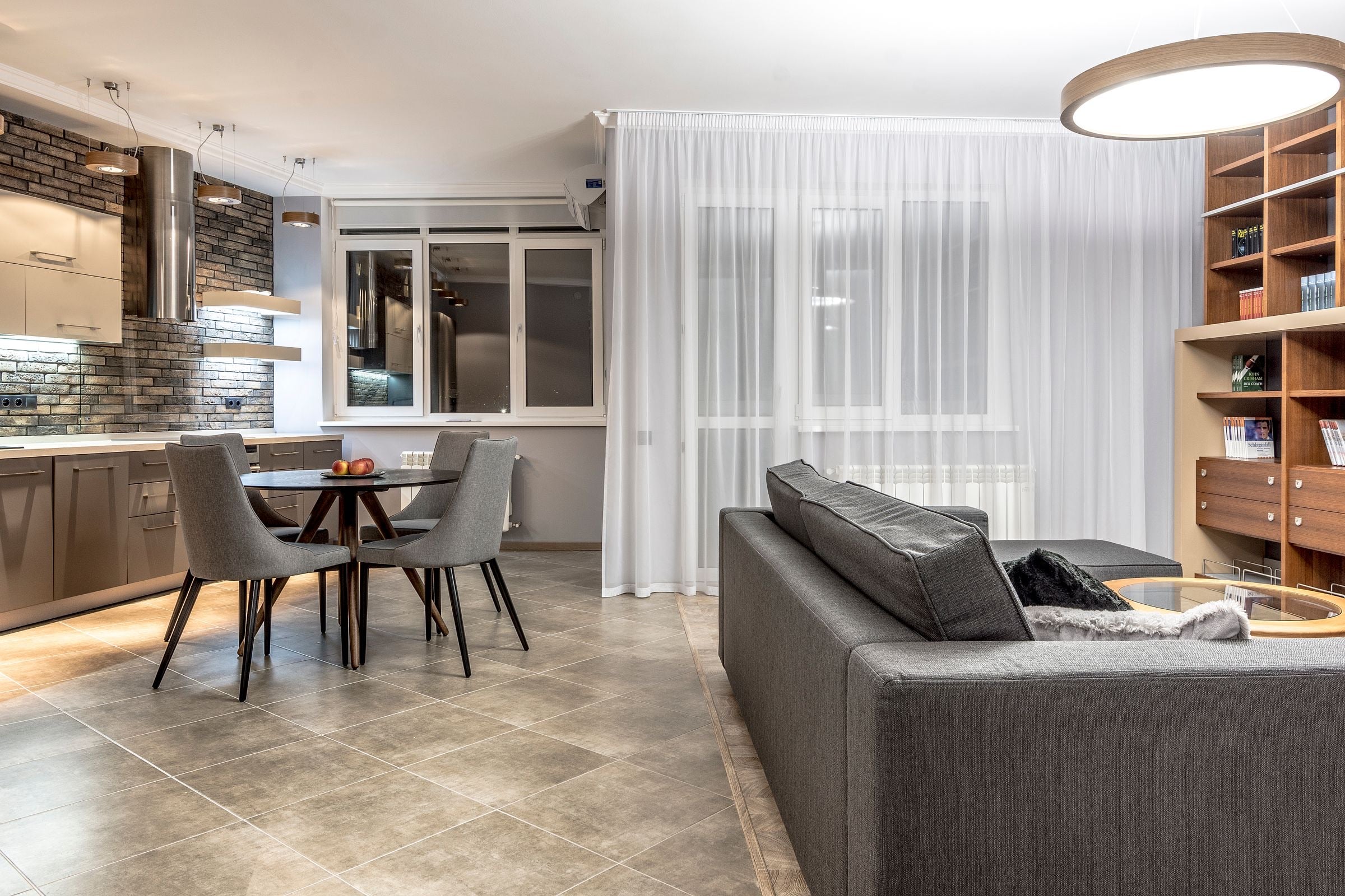 An open-plan furnished apartment with a living room and kitchen