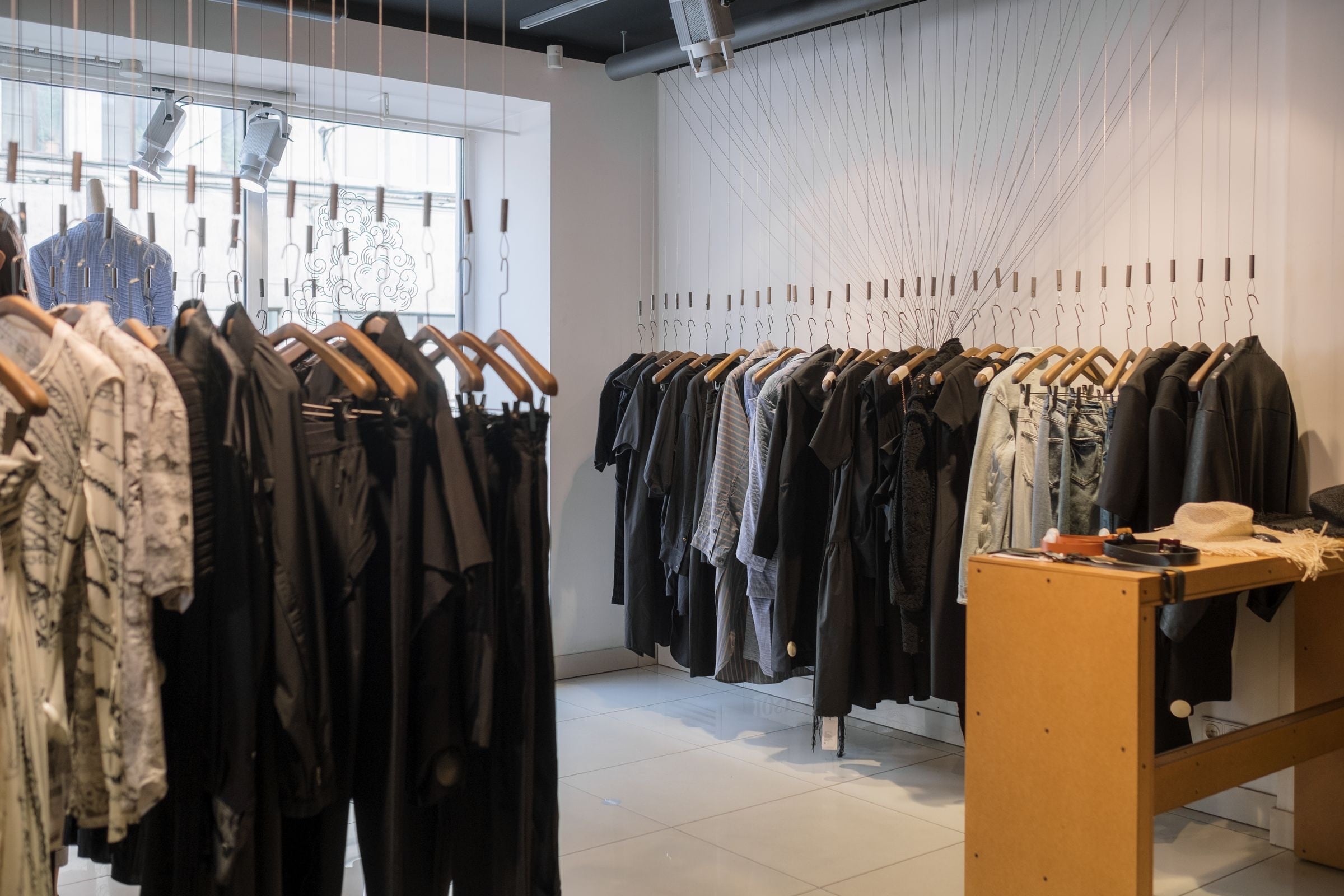 Clothing racks and displays in a bright, modern retail store